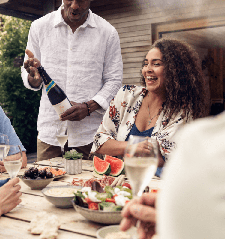 Ridgeview Wine Estate, English Sparkling Wine enjoyed at a summer party with a couple smiling (2)